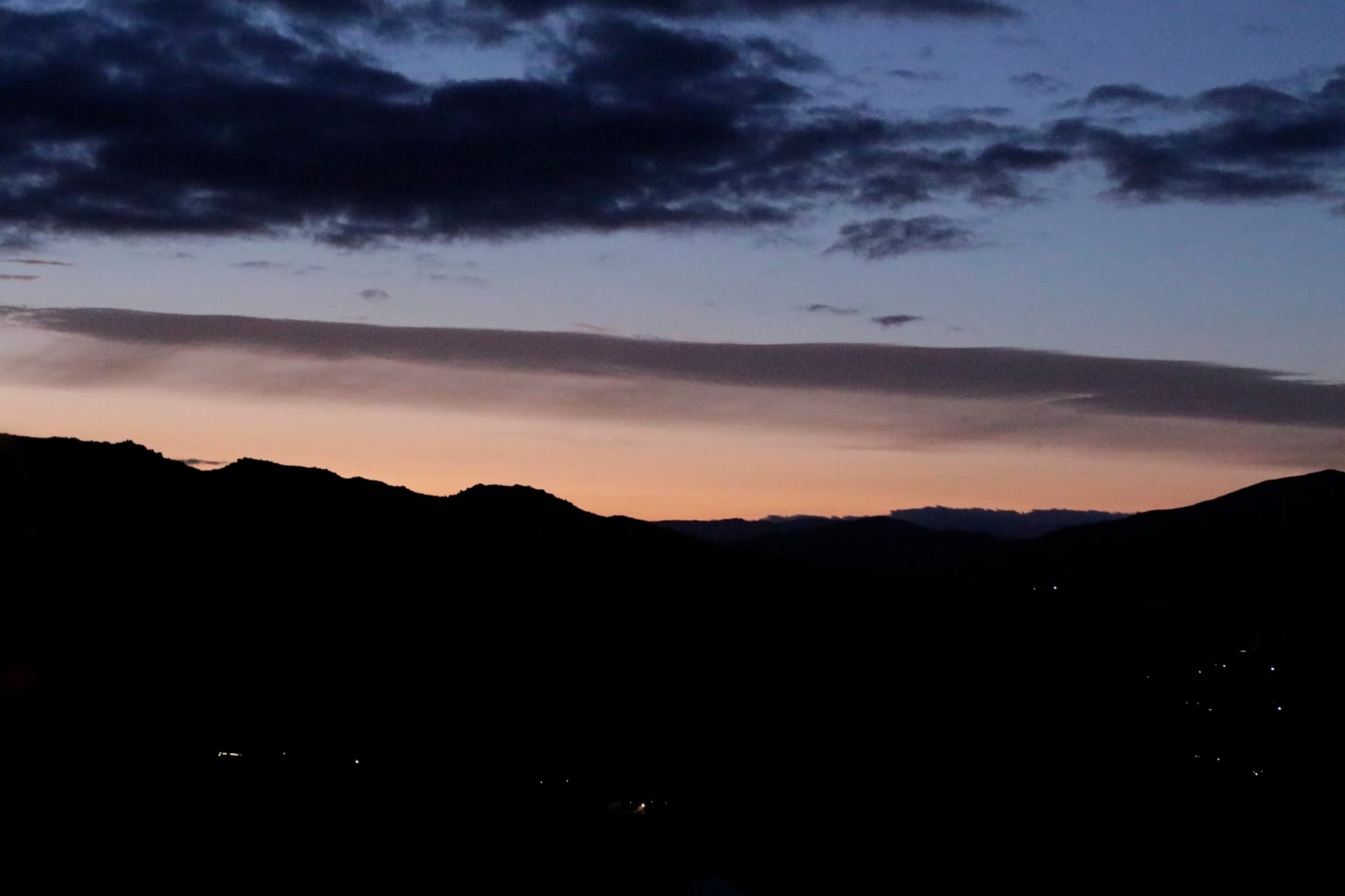 Silhouetted ridgeline over Valle de Guadalupe at dusk.
